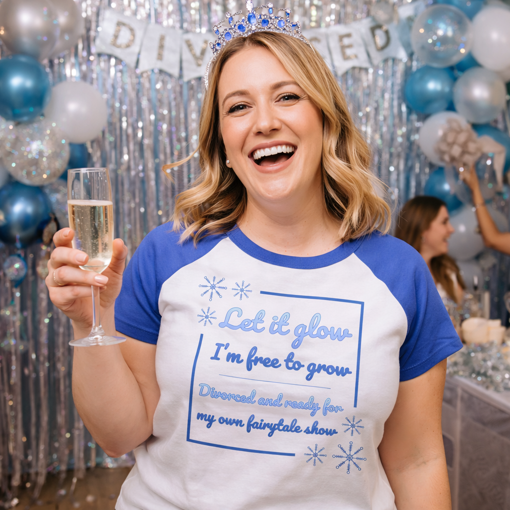 Smiling woman wearing fairytale inspired divorce party t-shirt at a celebration holding champagne with party decorations in background