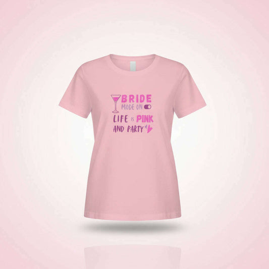 Pink women’s t-shirt with “Bride Crew – Life Pink and Party” slogan and cocktail icon, fun outfit for bachelorette party, girls trip or hen party celebration.