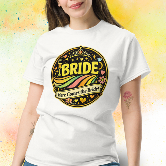 Woman wearing Bride Here Comes the Bride retro festival style t shirt with colorful vintage design, perfect outfit for bachelorette party and bridal celebration weekend white