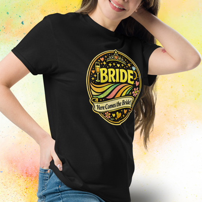 Woman wearing Bride Here Comes the Bride retro festival style t shirt with colorful vintage design, perfect outfit for bachelorette party and bridal celebration weekend black