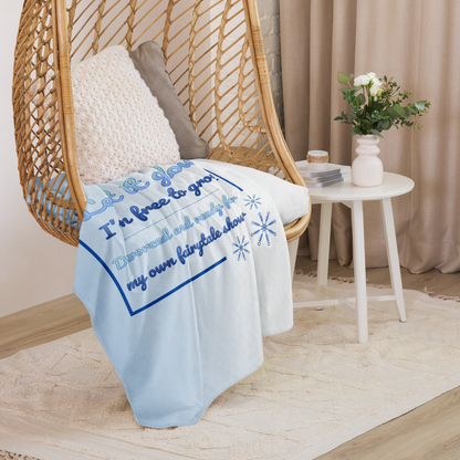 Soft blue Let it glow divorce party blanket draped over a chair in a cozy interior, perfect for celebration decor or gift