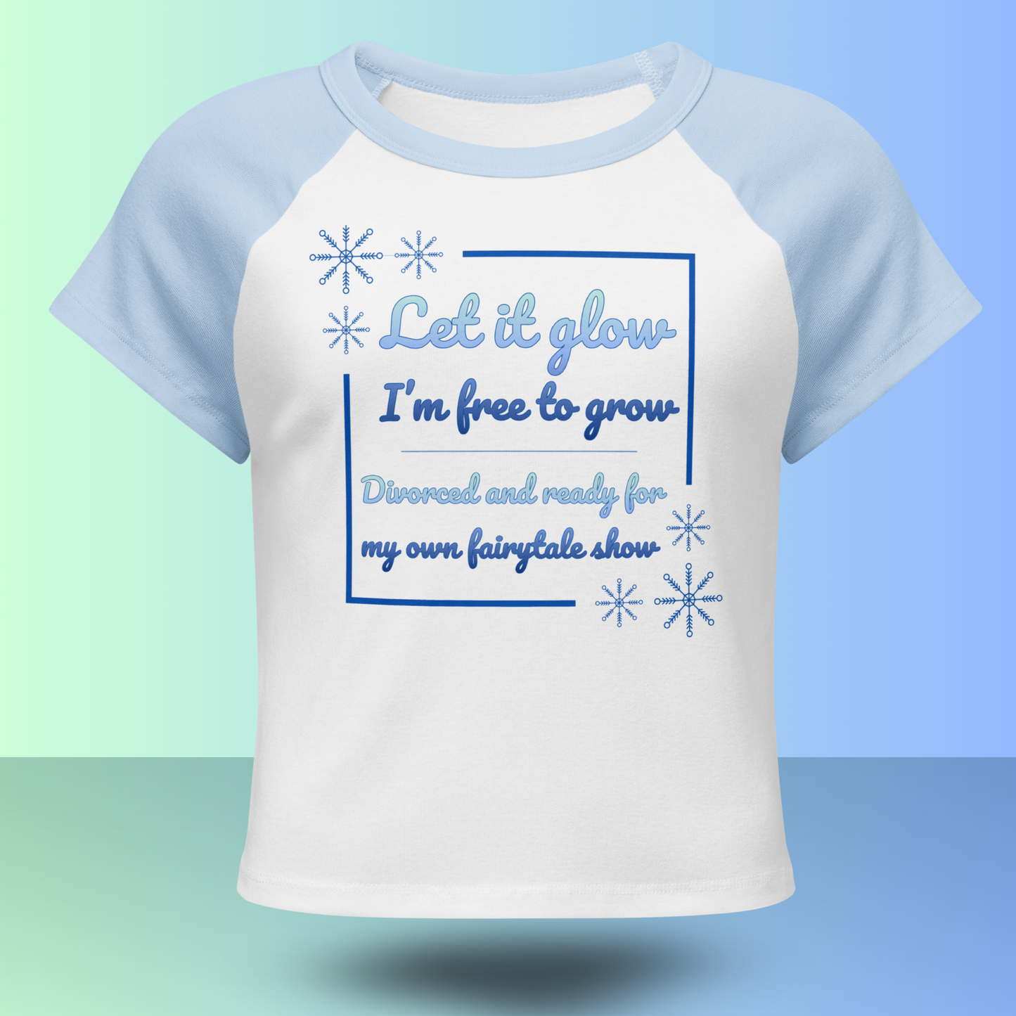 White and blue raglan t-shirt with Let it glow I’m free to grow divorce party slogan and snowflake graphics front view product mockup