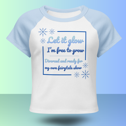 White and blue raglan t-shirt with Let it glow I’m free to grow divorce party slogan and snowflake graphics front view product mockup