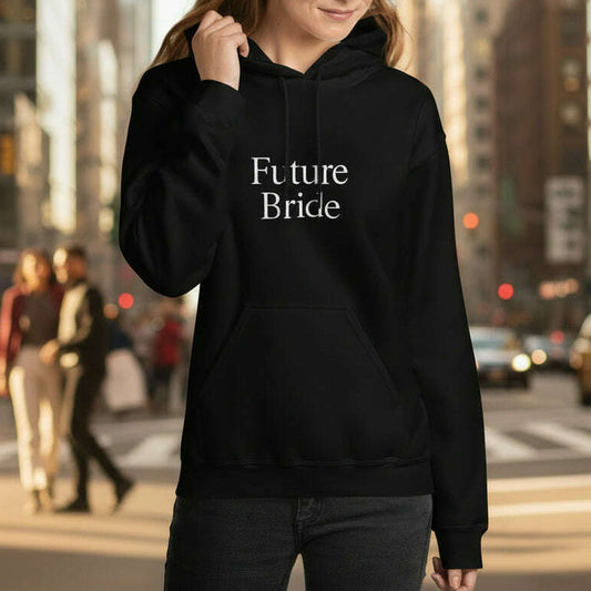 Woman wearing black hoodie with minimalist “Future Bride” white lettering, stylish outfit for bachelorette party, bridal shower or wedding weekend.