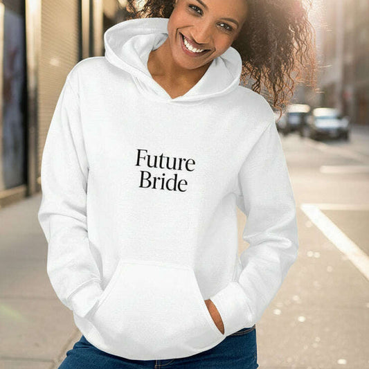 Woman smiling while wearing white hoodie with minimalist “Future Bride” text, stylish outfit for bachelorette party, bridal shower or wedding weekend.
