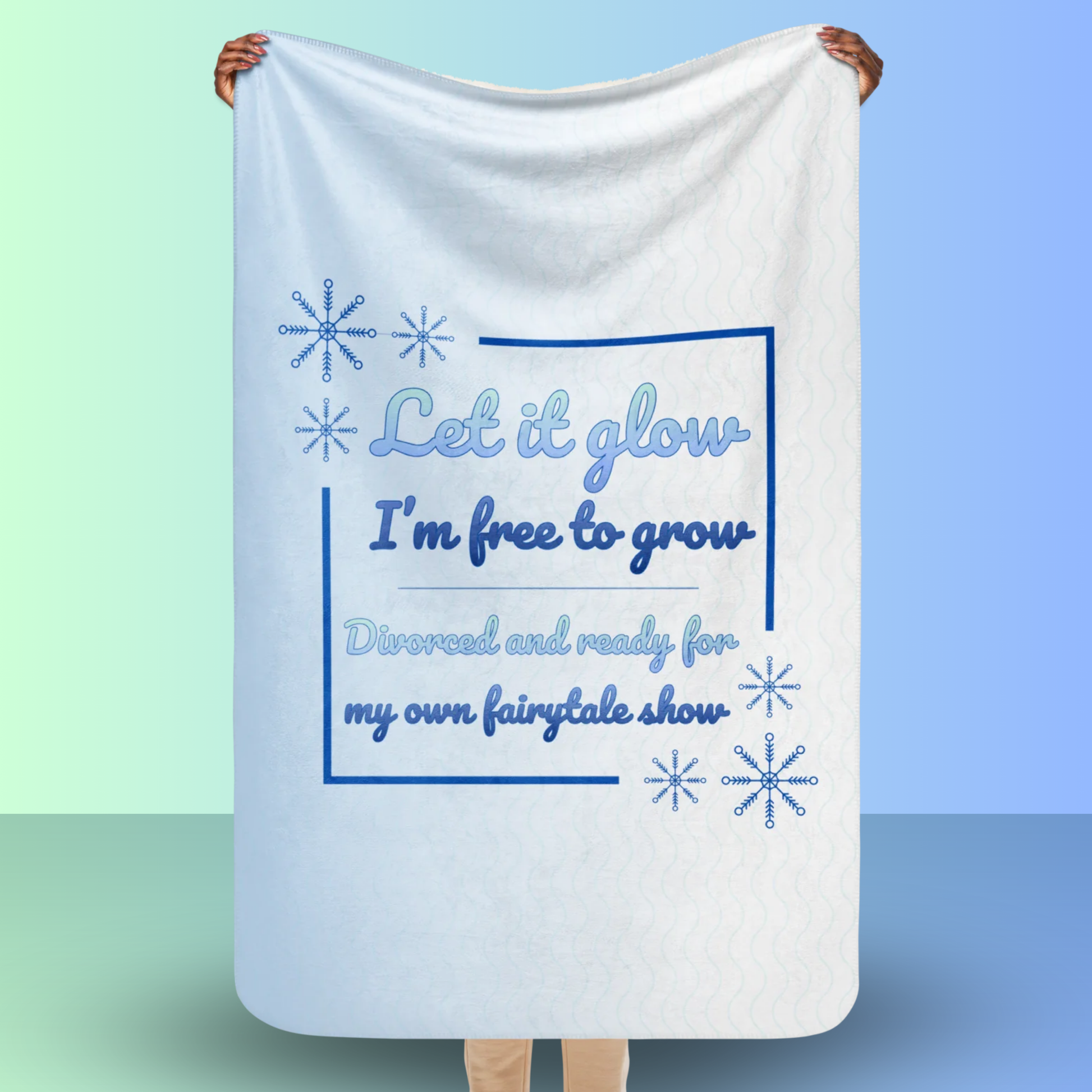 Person holding a Let it glow divorce party blanket with snowflake design and fairytale inspired slogan, perfect decoration or gift for a divorce celebration
