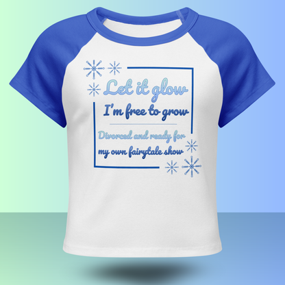 Front view of white and blue divorce party t-shirt with fairytale inspired Let it glow slogan and snowflake design
