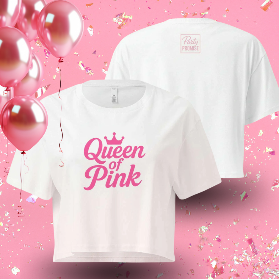 White crop top with pink “Queen of Pink” graphic displayed with balloons, perfect outfit for pink themed party or bachelorette celebration.