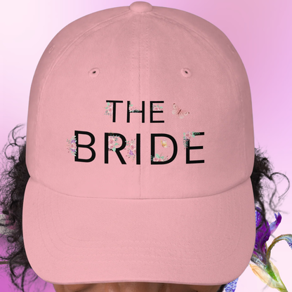 Pink The Bride embroidered dad hat displayed on model, ideal accessory for future bride during bachelorette party celebration.