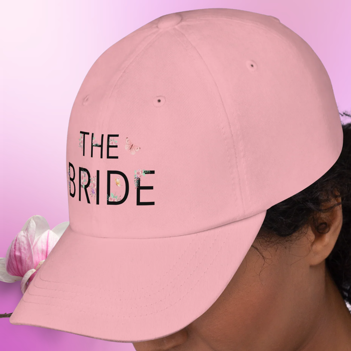 Pink embroidered The Bride dad hat worn on model, ideal casual accessory for bride during bachelorette party or girls trip.