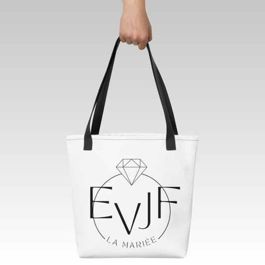 Sac tote bag EVJF La Mariée en toile blanche avec anses noires porté à la main pour enterrement de vie de jeune fille