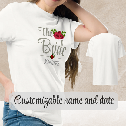 Woman wearing a white “The Bride” personalized t-shirt with custom name and floral design.