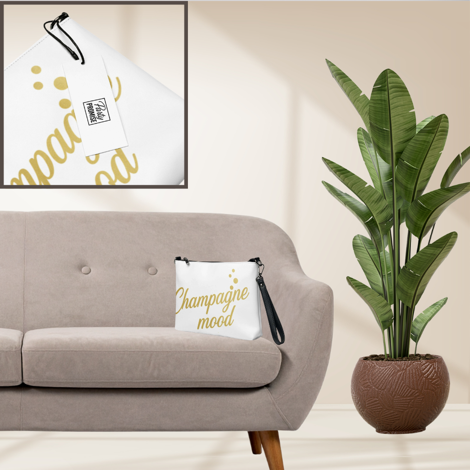 White pillow with gold Champagne Mood lettering displayed on sofa with champagne themed artwork, elegant decor for bridal shower or champagne party