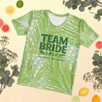Model wearing the Tropical Team Bride t-shirt with jungle leaf print and pink slogan. The bright design and short-sleeve fit create a fresh summer look.
