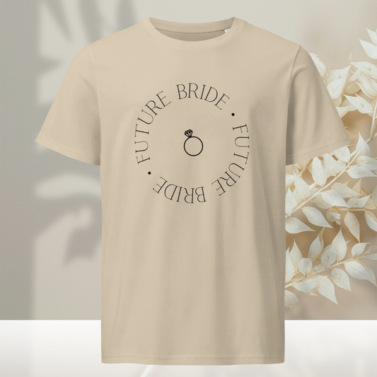 Close up of a man wearing a sand color organic t-shirt with a minimal future bride circle design and engagement ring icon