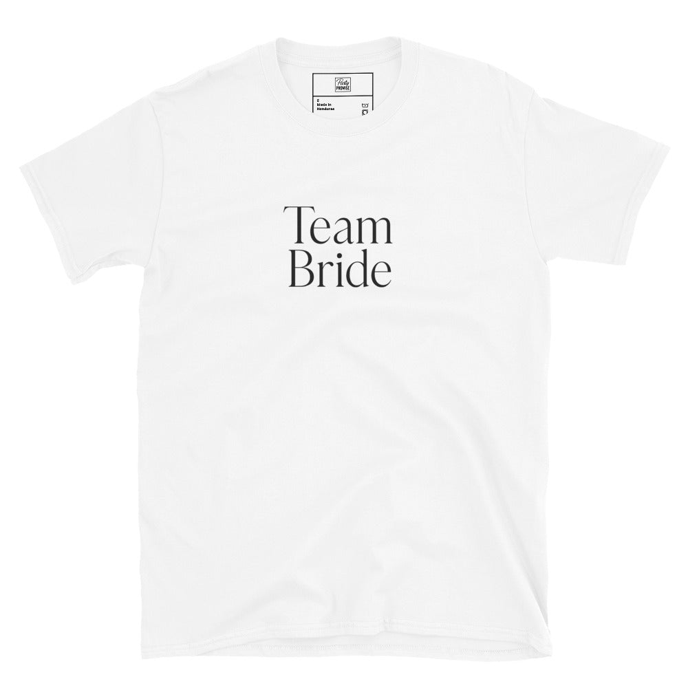 A flatlay of the white Team Bride t-shirt with black writing, styled with accessories for a bachelorette theme. The bright white fabric contrasts beautifully with the modern typography.