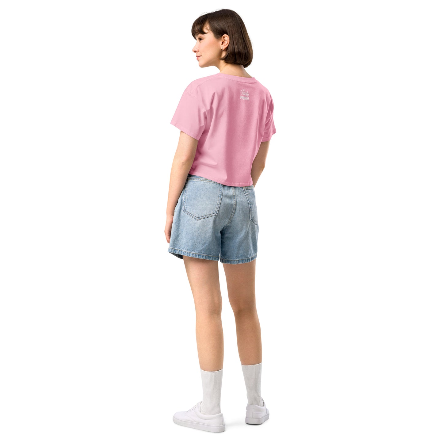 Side view of the cropped pink tee showing the dropped shoulders and loose silhouette. The white slogan stands out clearly for a fresh Pink Party look.