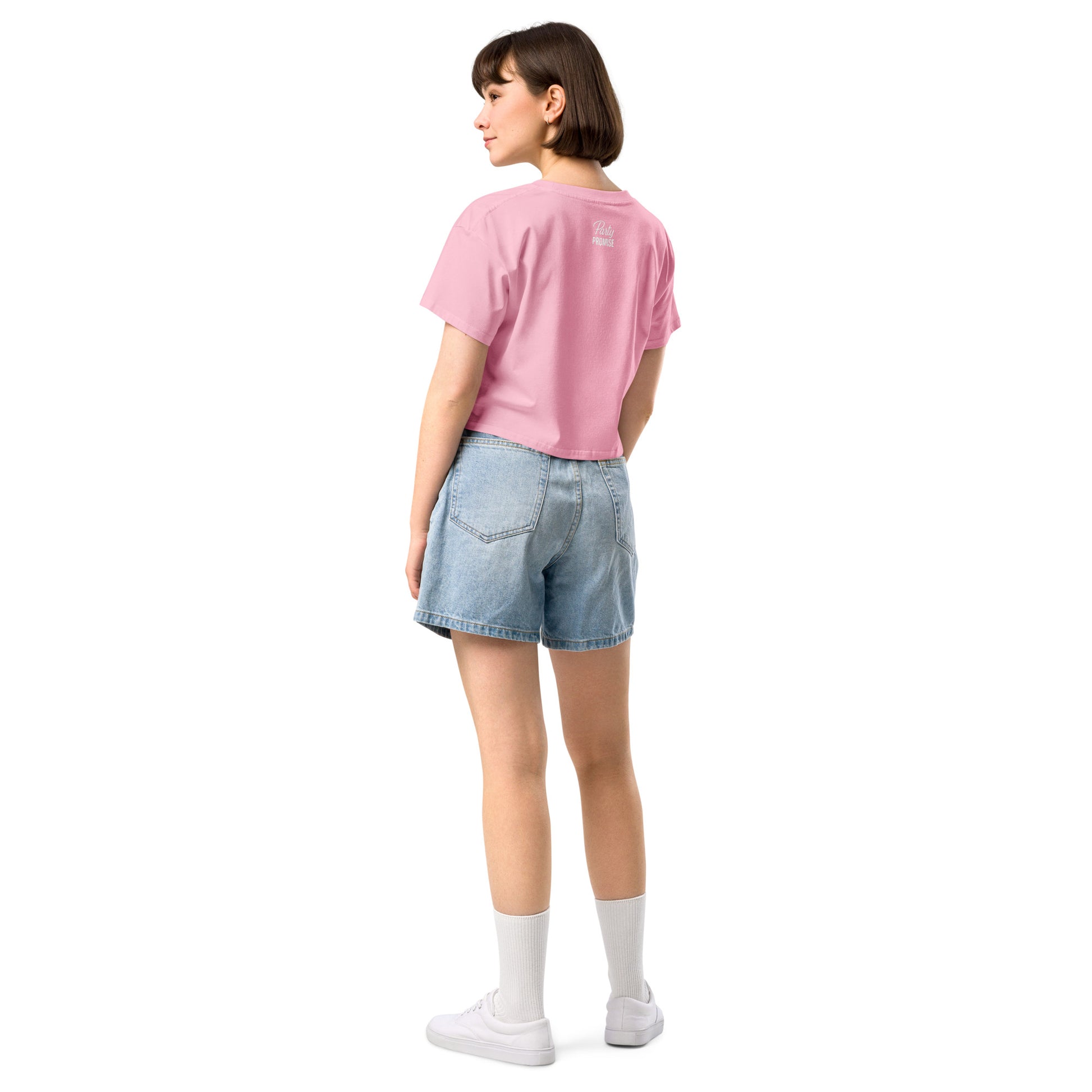Side view of the cropped pink tee showing the dropped shoulders and loose silhouette. The white slogan stands out clearly for a fresh Pink Party look.