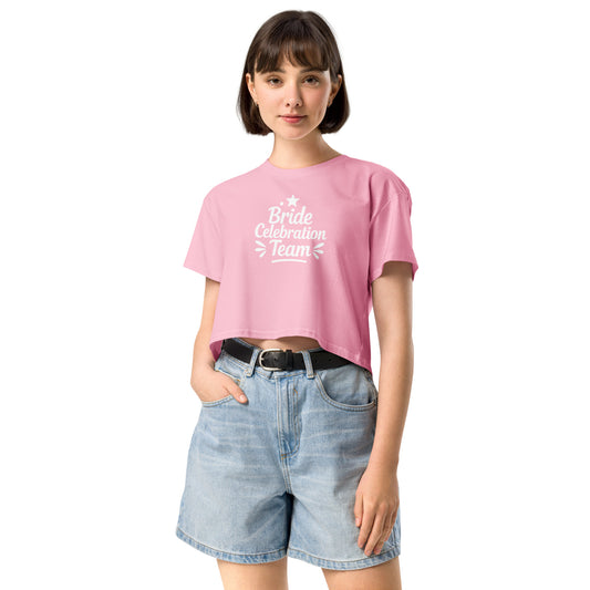 Model wearing the pink “Bride Celebration Team” crop top against a clean white background. The relaxed fit and soft cotton texture highlight its modern and feminine style.